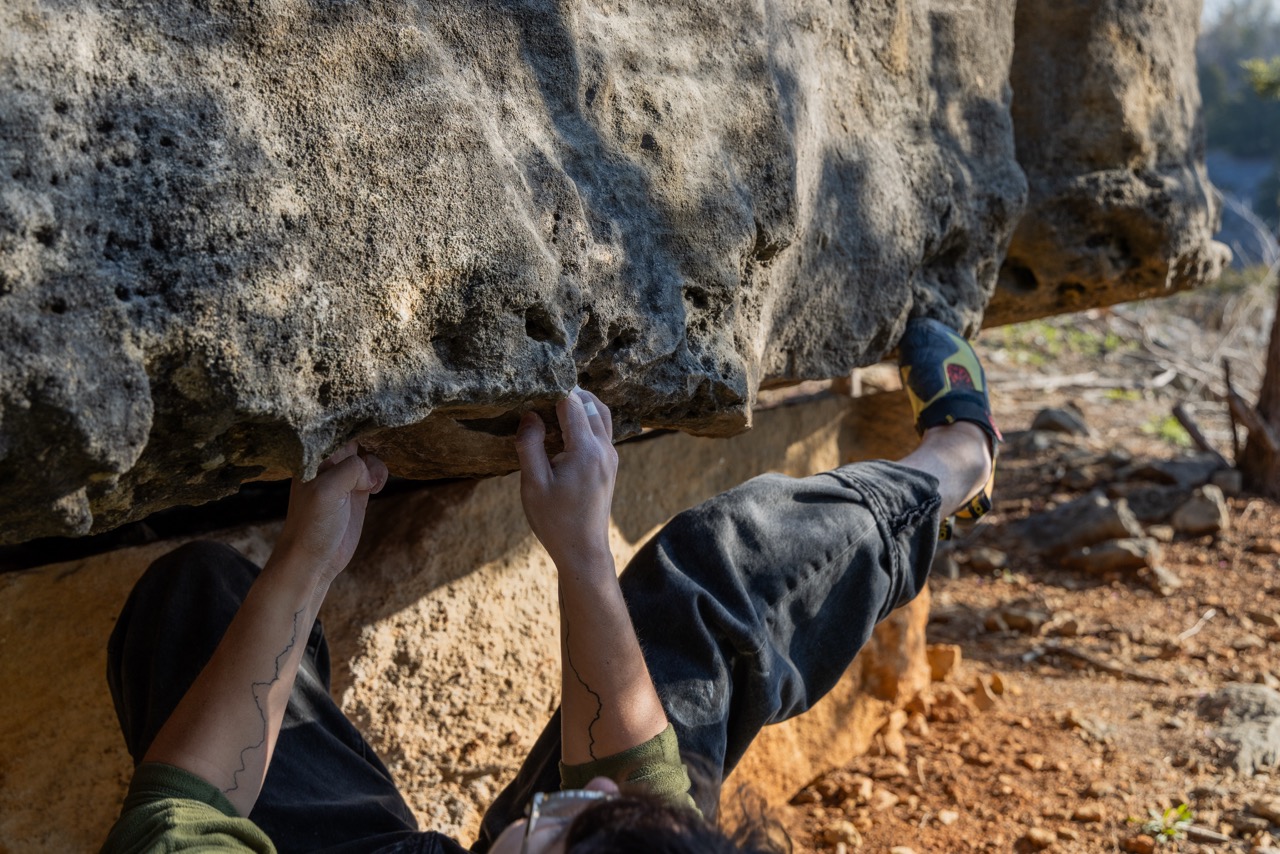 hanging under roof while climbing