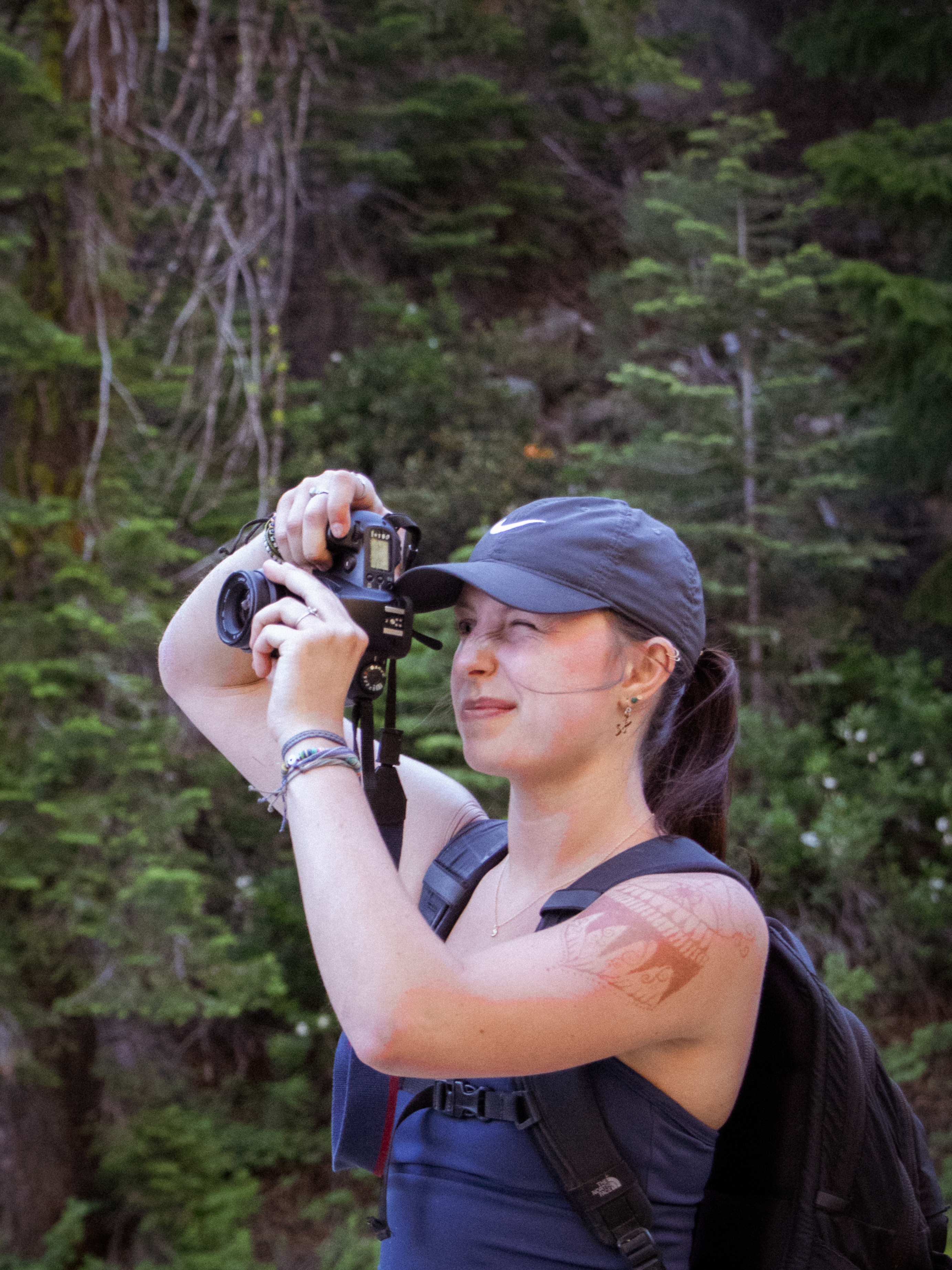 girl takng photo of something off frame